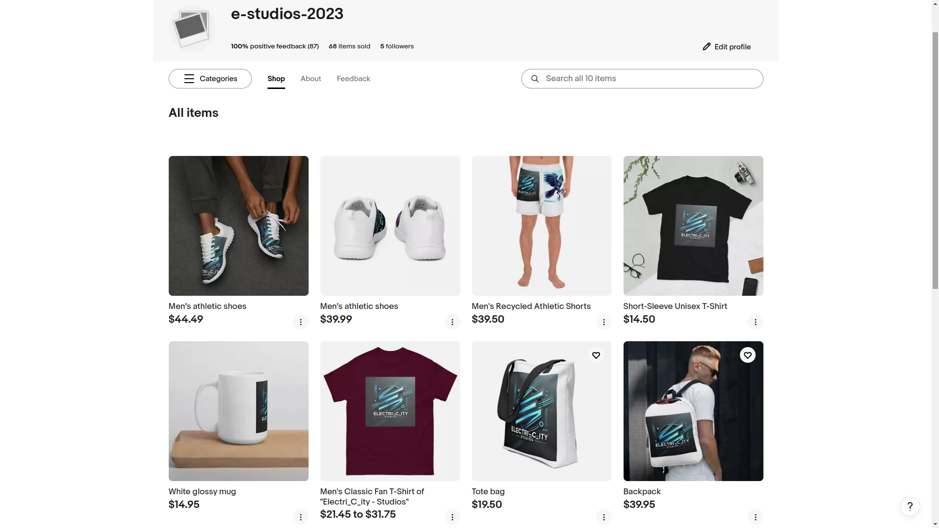 Screenshot of an online store named "e-studios-2023" featuring items like men's athletic shoes, shorts, a T-shirt, a glossy mug, canvas sneakers, a tote bag, and a backpack with prices ranging from $14.50 to $137.57. .